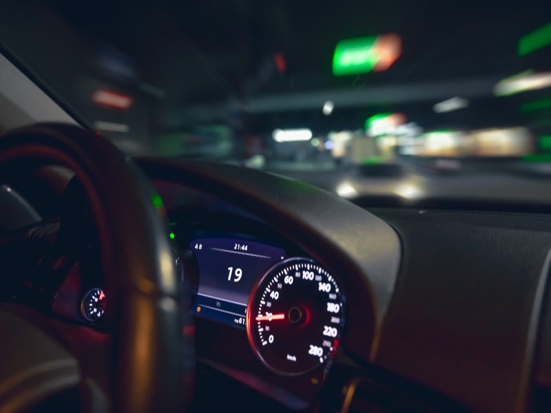 car-steering-wheel-view-night-road-from-car-closeup