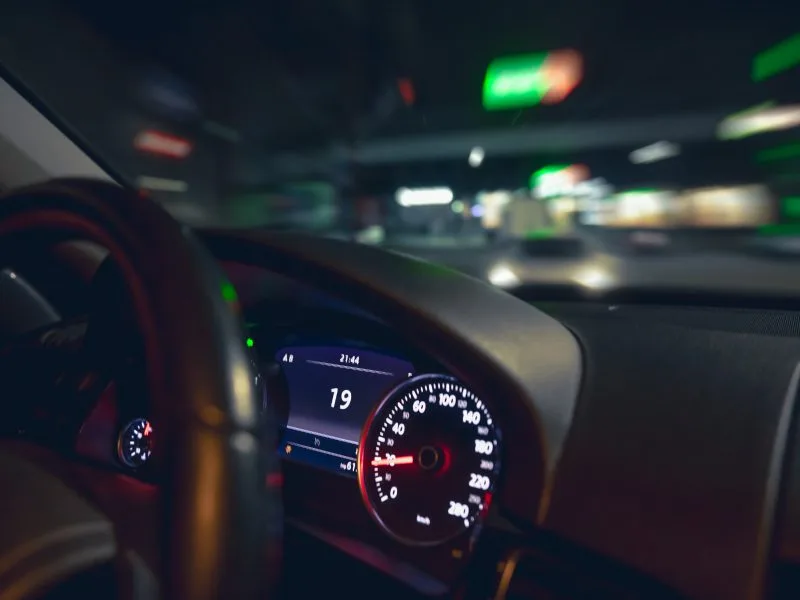 car steering wheel view night road from car-closeup